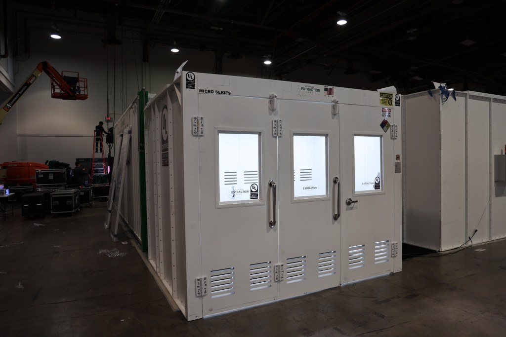 Advanced Extraction Labs white M8 show booth displayed inside showroom